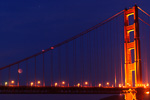 Eclipsed moon through the Golden Gate Bridge cables